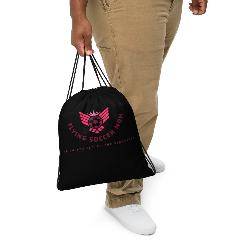 Soccer mom holding Flying Soccer Mom Drawstring Bag Black with the string
