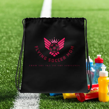 Flying Soccer Mom Drawstring Bag Black on the soccer field