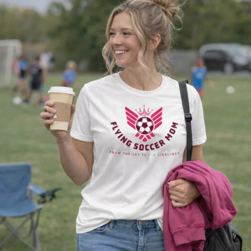 Flying Soccer Mom relaxed fit game day tee in white worn by a woman at a soccer field