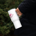 Soccer mom stainless steel tumbler with handle held by a person in a black jacket outdoors.
