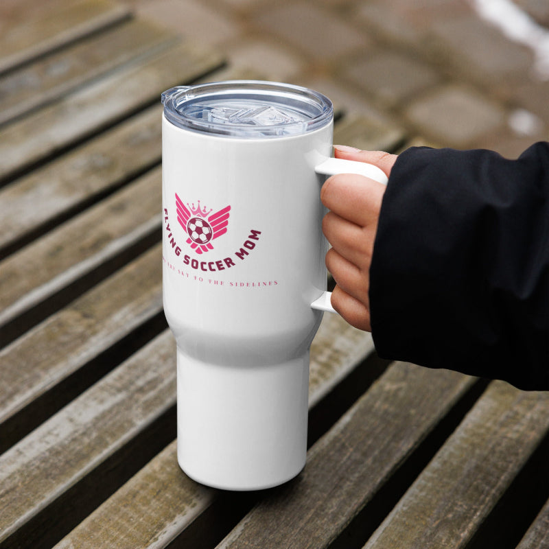 Soccer mom stainless steel tumbler with handle held on wooden surface, perfect for busy mornings and game days.